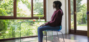 serene woman meditating in tranquil home office